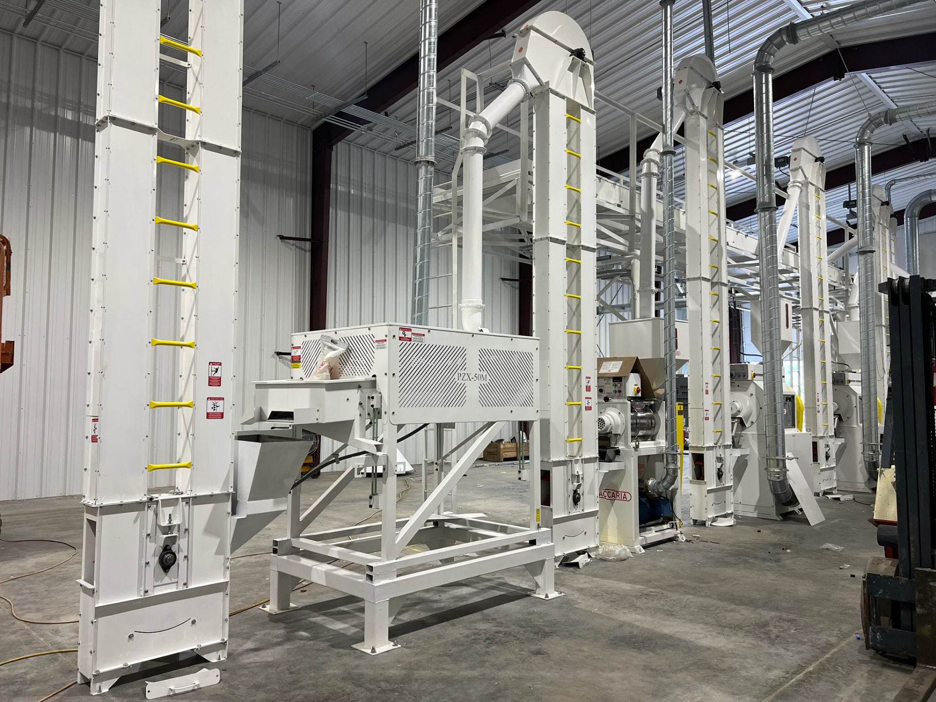 On-farm rice mill facility in Tennessee with milling equipment and storage under a metal roof