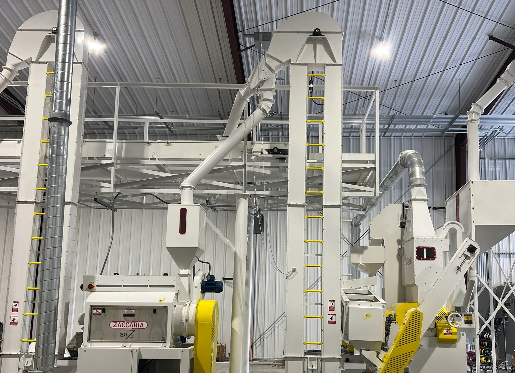 Grain elevators, conveyors, and processing equipment inside a bright grain-processing facility