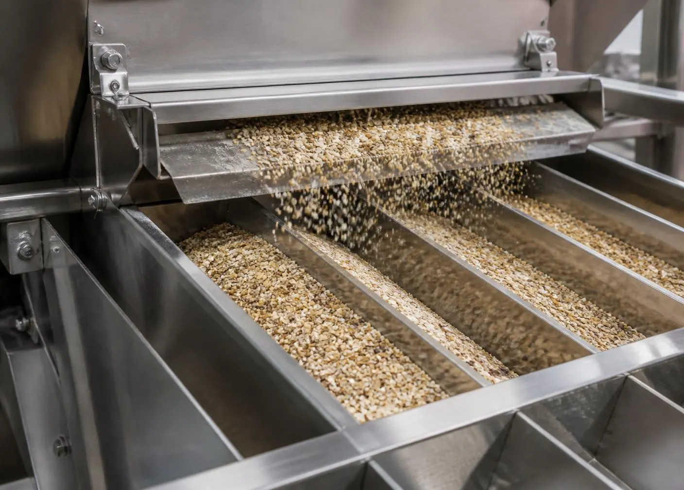 Quinoa and specialty grains moving through commercial stainless steel grain cleaning equipment